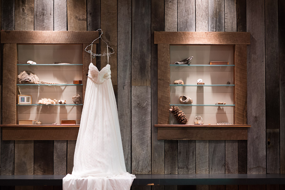 Caroline's boutique wedding dress from The Gown Shop, Ann Arbor. Dress hung on the wall of the basement of the main lodge.